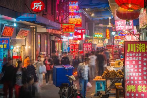 China restaurants and night markets illuminated in crowded Beijing streets