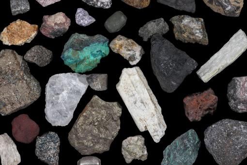Spaced mixture of mine, mining ores, commodities, metals, coal. Background concept, texture, rocks. Variety, mixed, many, multi-colored, colorful.