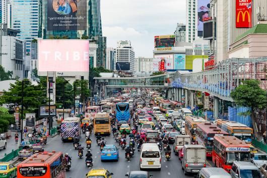 The exclusive district of Sukhumvit, Bangkok, Thailand, seen during a late afternoon in the autumn. Skyscrapers rising and crowded traffic on the streets.