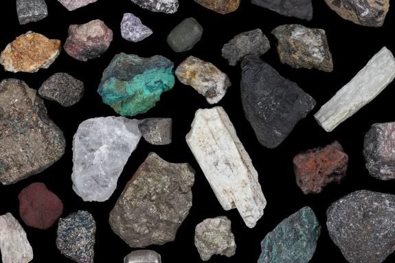 Spaced mixture of mine, mining ores, commodities, metals, coal. Background concept, texture, rocks. Variety, mixed, many, multi-colored, colorful.